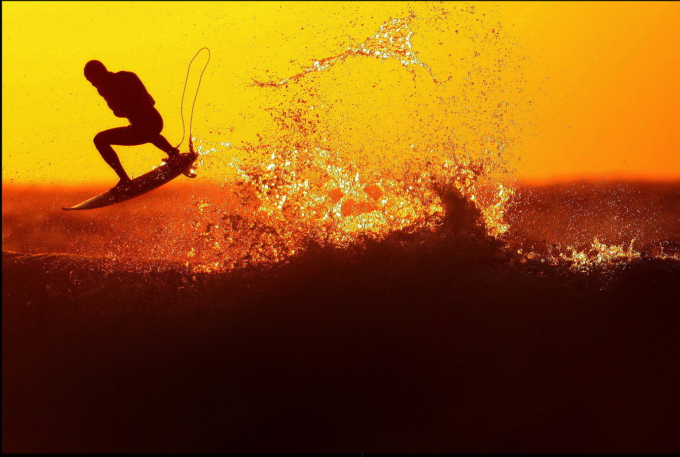 Surfer at golden sunset